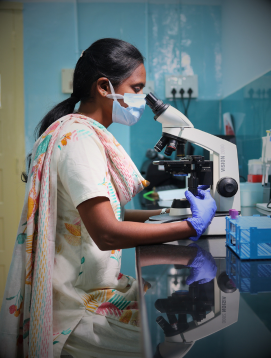 A researcher at the microscope in a CMC Vellore laboratory