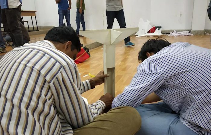 Students measuring a model airframe during a workshop activity