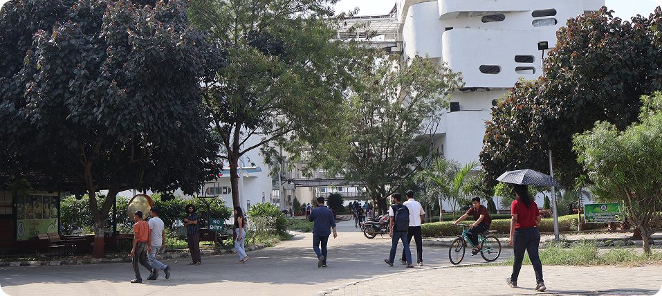 Students crossing the IIT Indore campus with the POD academic block behind