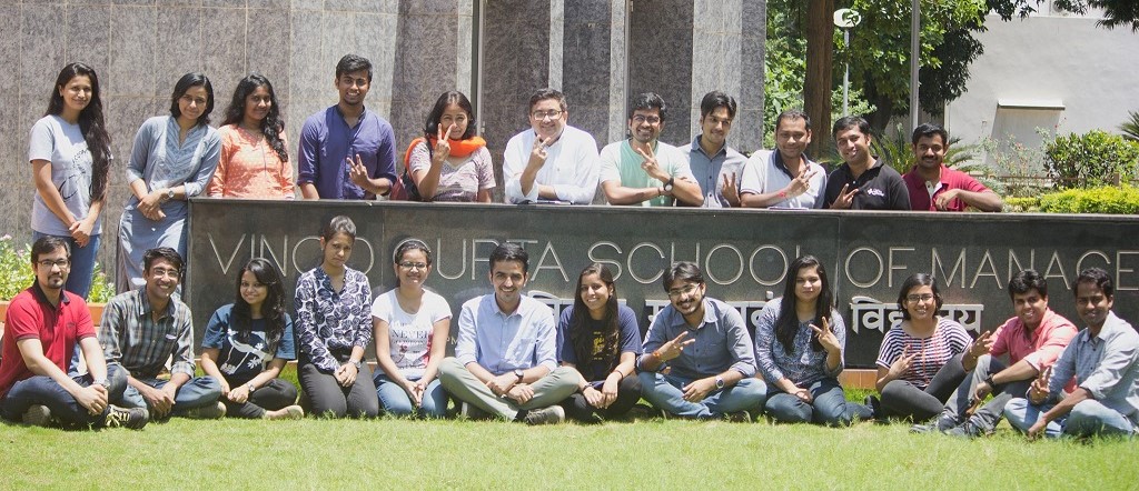 Students at the Vinod Gupta School of Management signboard on the IIT Kharagpur campus