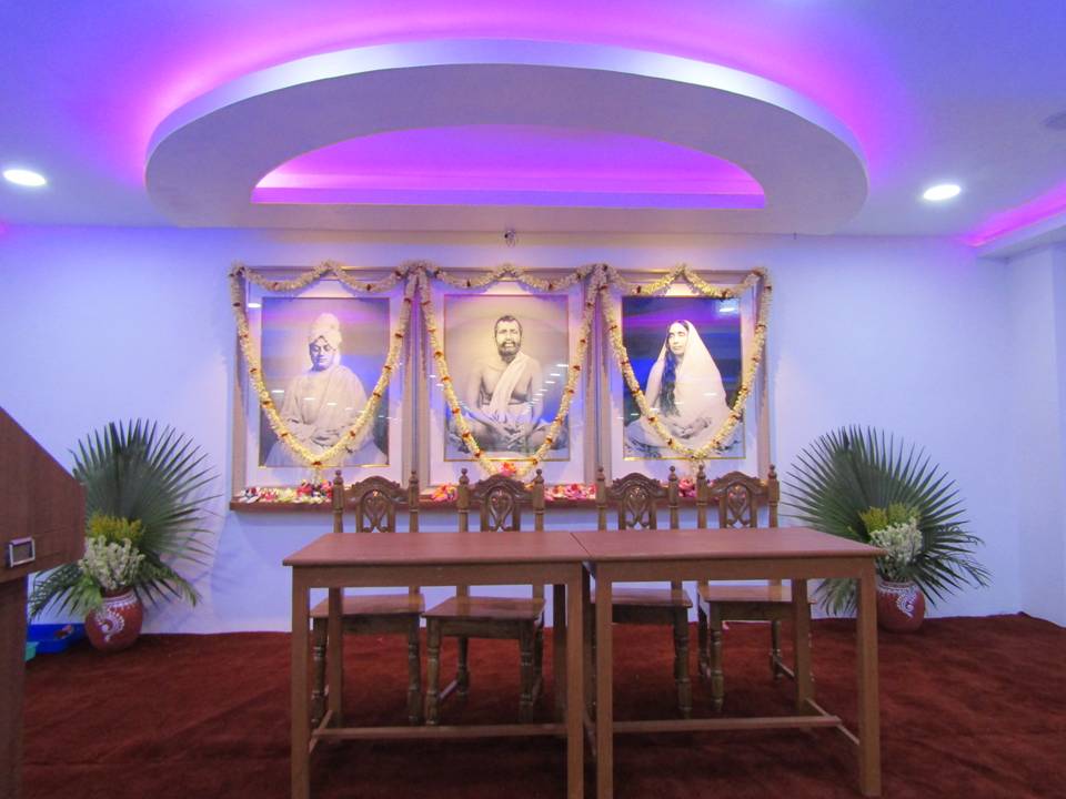 Prayer hall at Ramakrishna Mission Vivekananda Centenary College with portraits of Swami Vivekananda, Sri Ramakrishna and Sri Sarada Devi