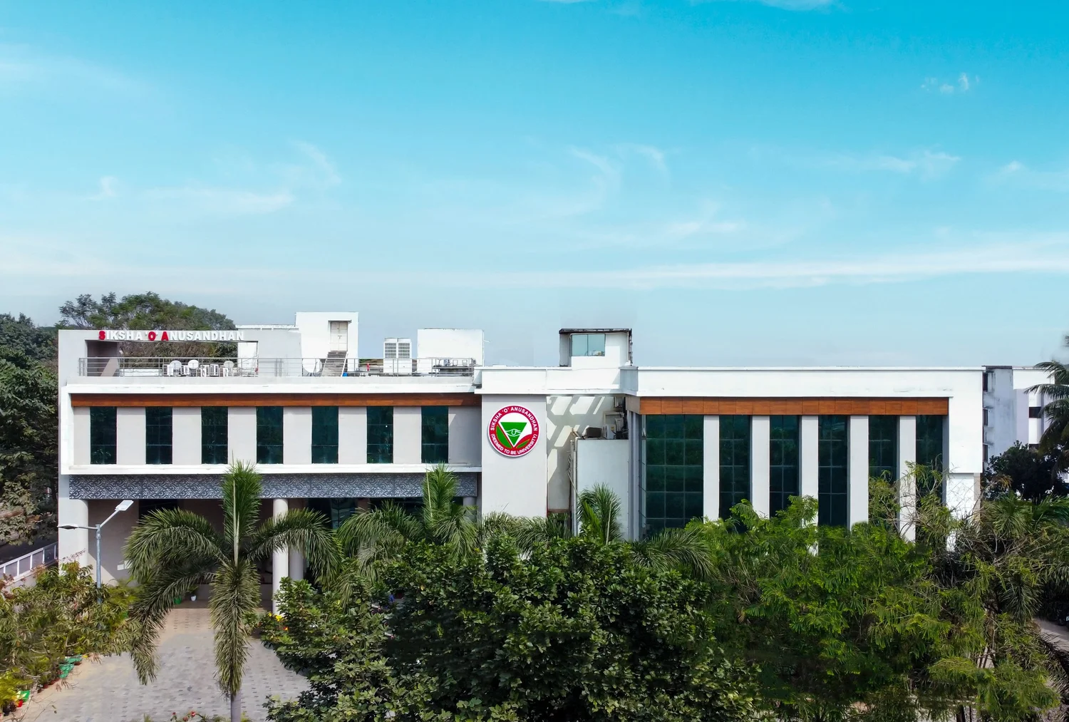 A Siksha 'O' Anusandhan academic building carrying the university crest and name board