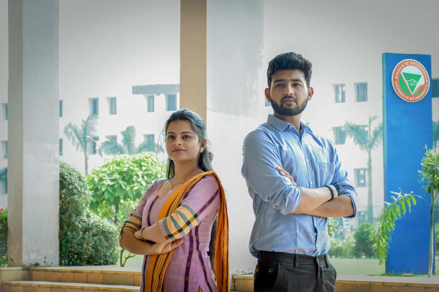 Students beside a Siksha 'O' Anusandhan campus signage pillar