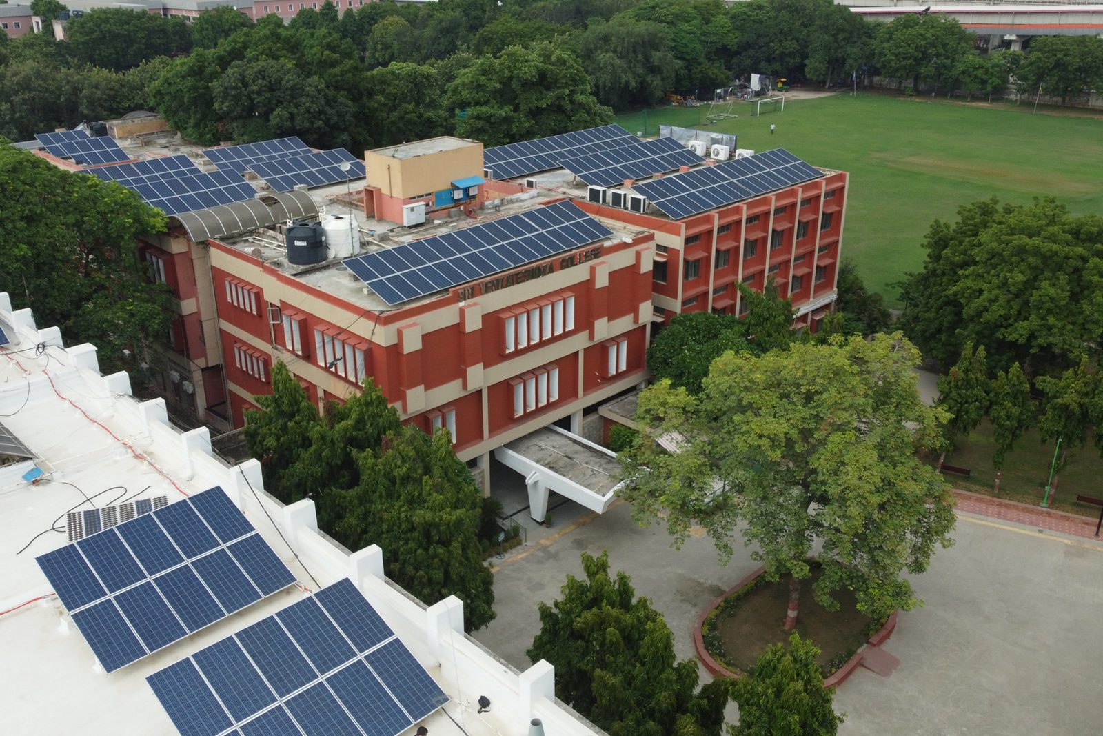 College blocks, rooftop solar array and the playing field at Sri Venkateswara College